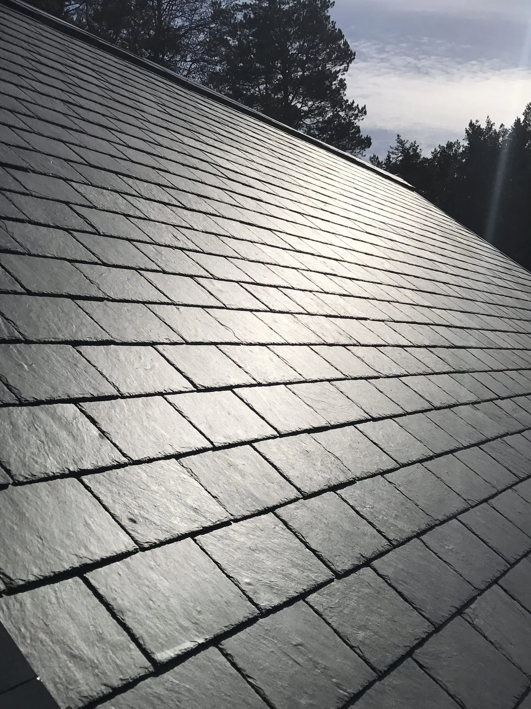Wet natural slate courses, thick and dark, with no lettering.
